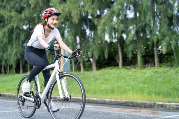 Asian young sport woman riding bicycle in the evening in public park.