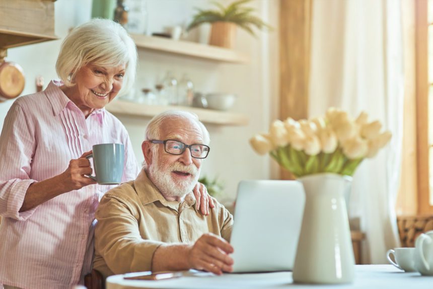 Happy elderly couple is having breakfast at home