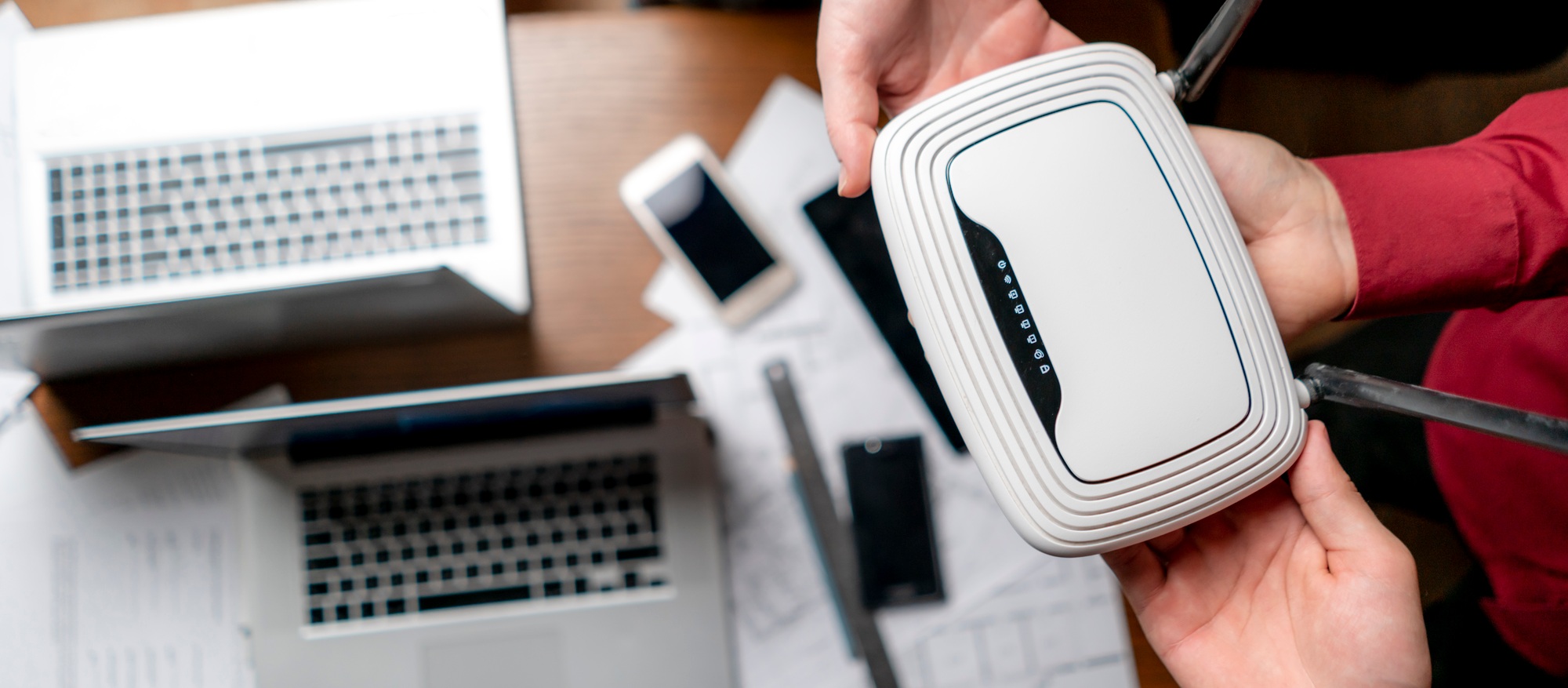top view of group of people hold wi-fi router, wireless connection concept