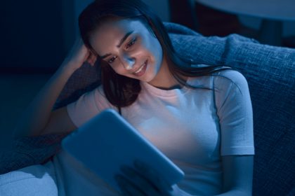 Woman reading e book in evening